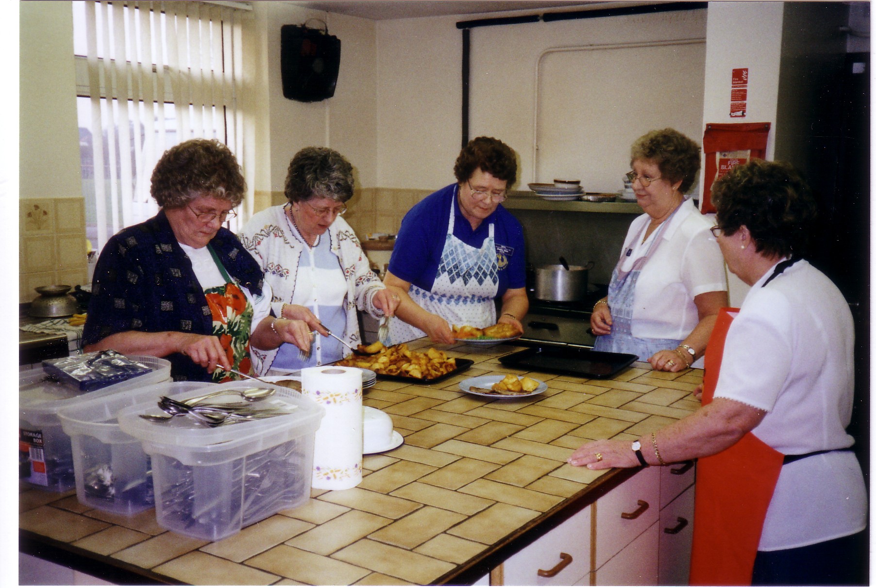 Margaret (left) and Pauline (centre) preparing food for members of RAF Central Band